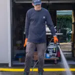 seattle suds pressure washer washing a driveway