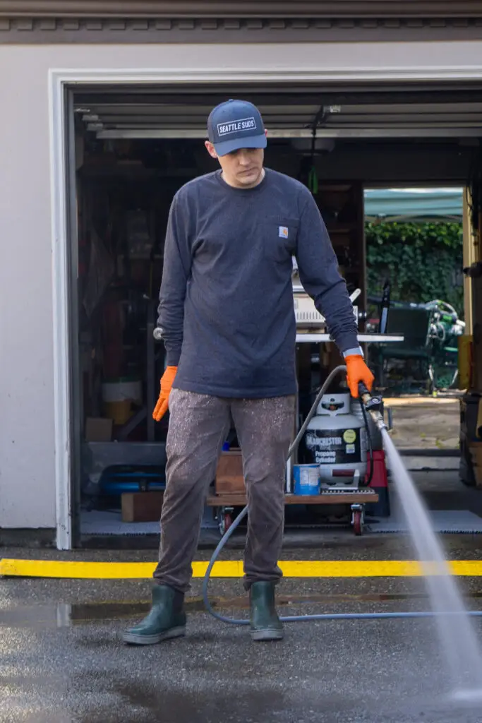 seattle suds pressure washer washing a driveway